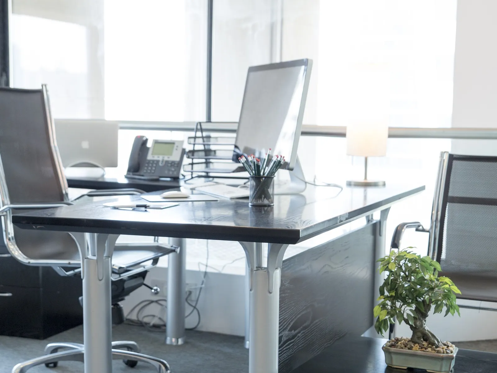 a desk with a computer and other office supplies